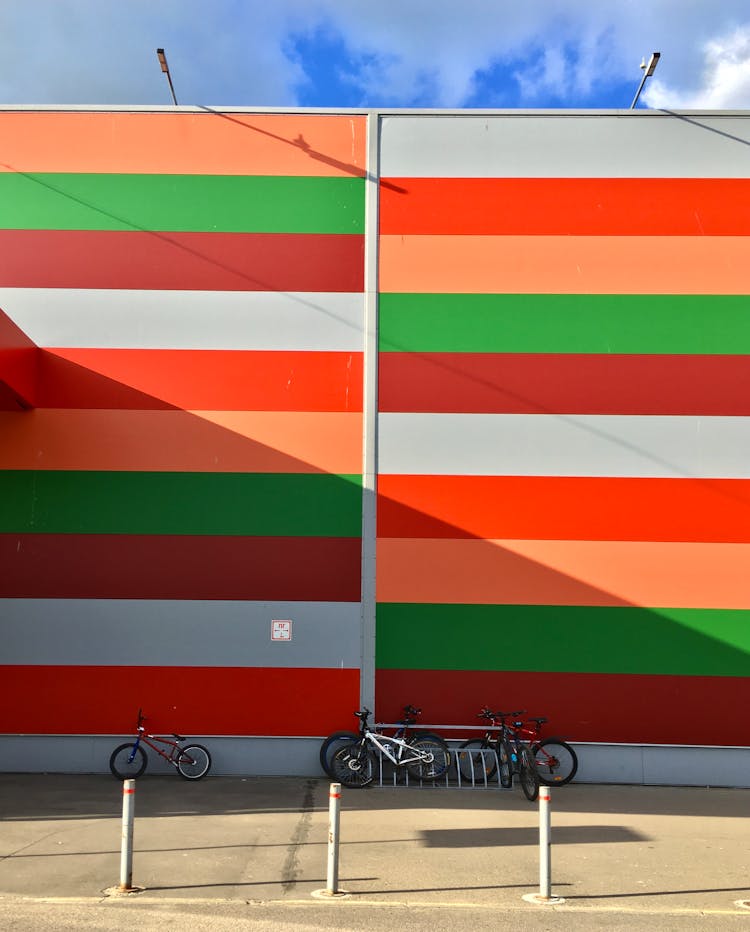 Bicycles Parked Near Colorful Wall