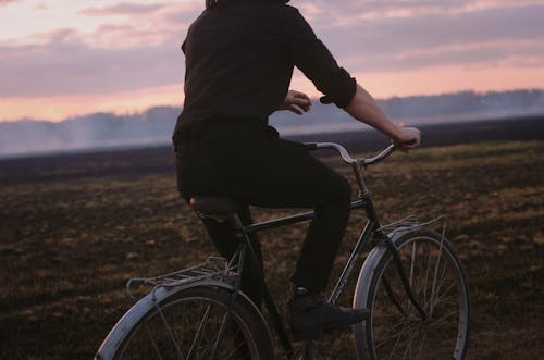 Free Photograph of a Person in a Black Shirt Riding a Bicycle Stock Photo