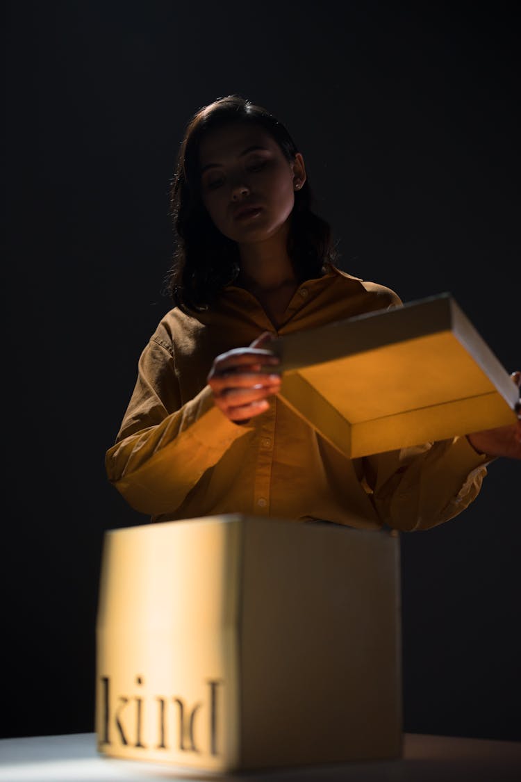 A Woman Opening A Box