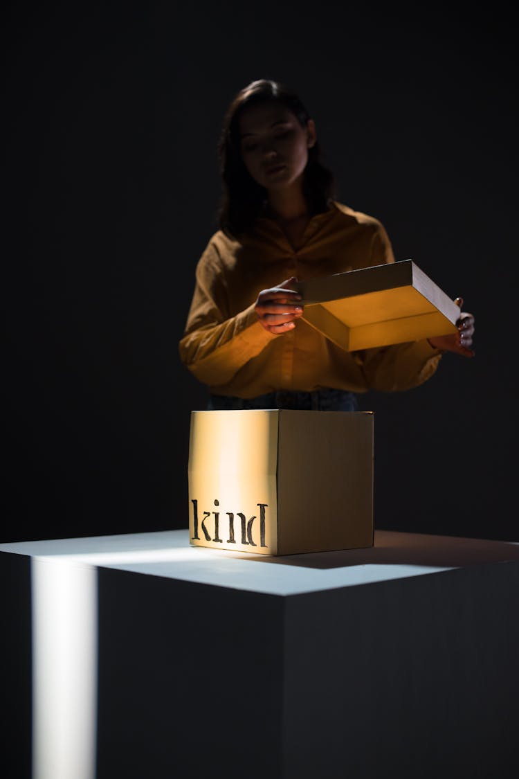 A Woman Opening A Kind Box