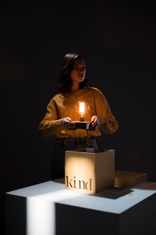 Woman holding a Lighted Light Bulb