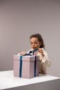 Girl untying the Ribbon of the Box