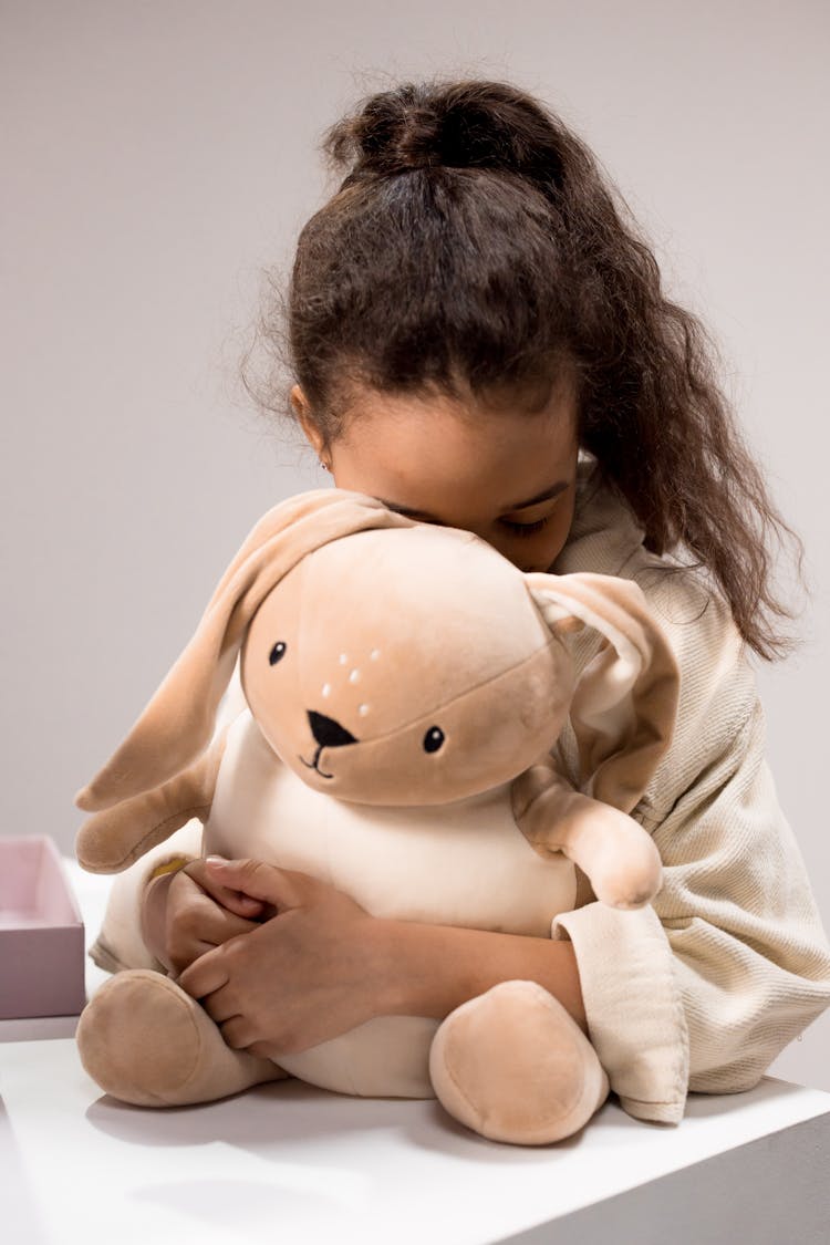 A Girl Holding A Stuffed Toy