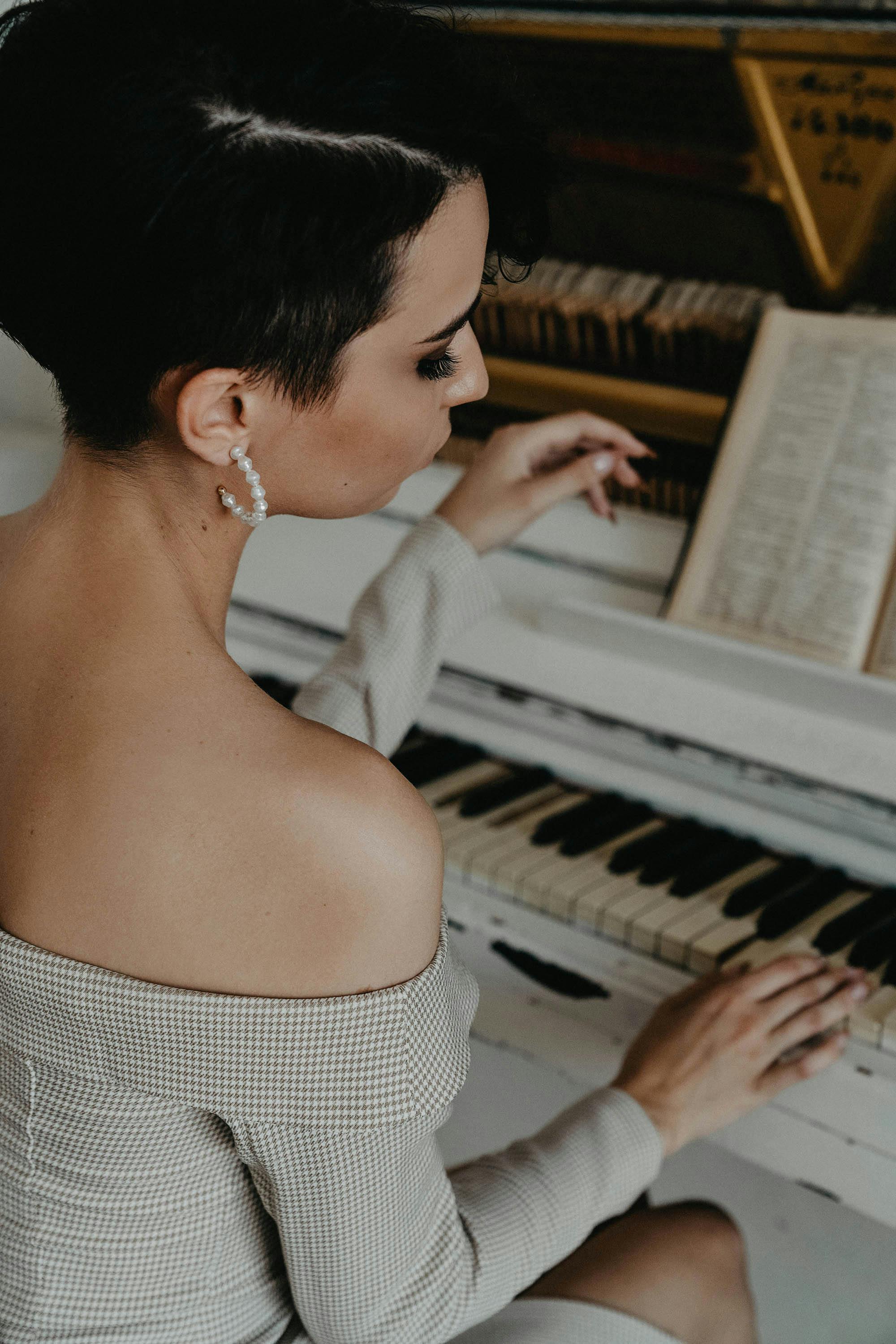 Piano sheet music and a pianist's hands on the keys