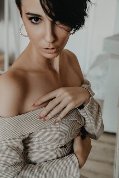 Close-Up Shot of a Short-Haired Woman in Off Shoulder Top Posing