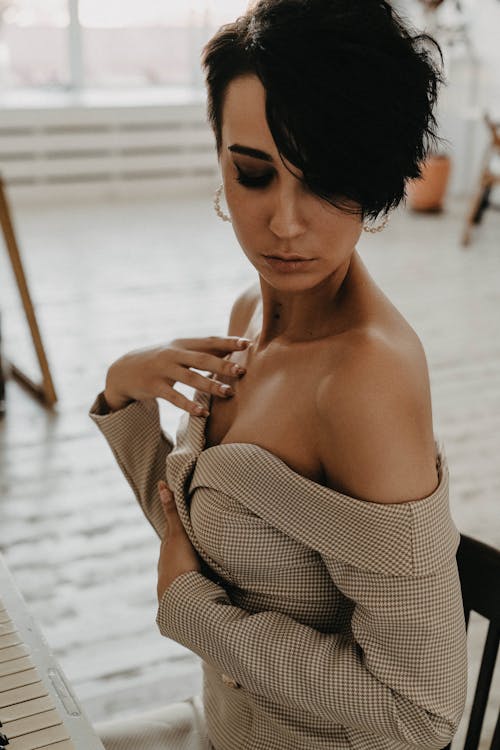 Close-Up Shot of a Short-Haired Woman in Off Shoulder Top Posing