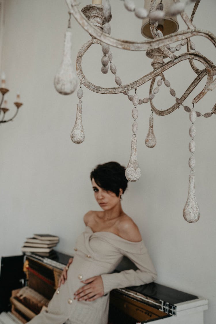 A Woman In Off Shoulder Dress Leaning On A Counter