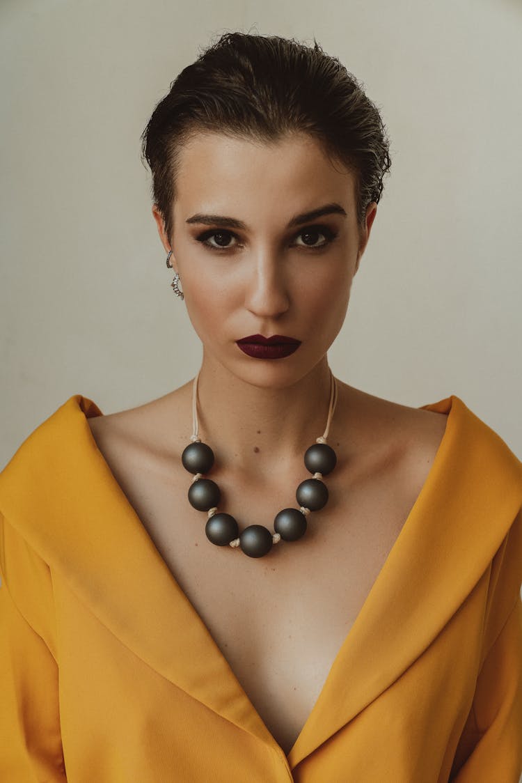 Woman With Black Pearl Necklace And Yellow Dress