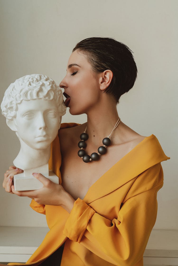 Woman Holding White Head Statue