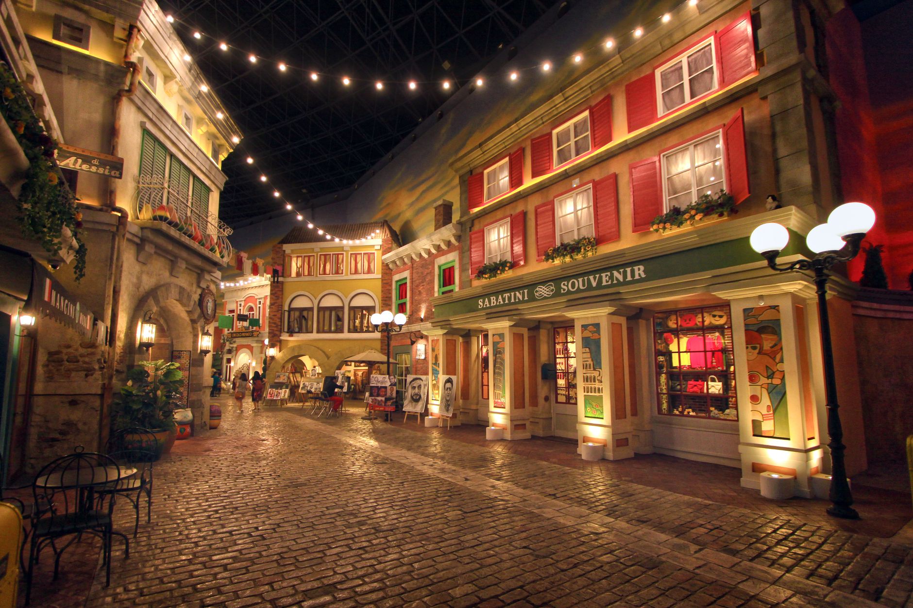 A picturesque street in Dubai Mall's indoor replica of a traditional European village at night.