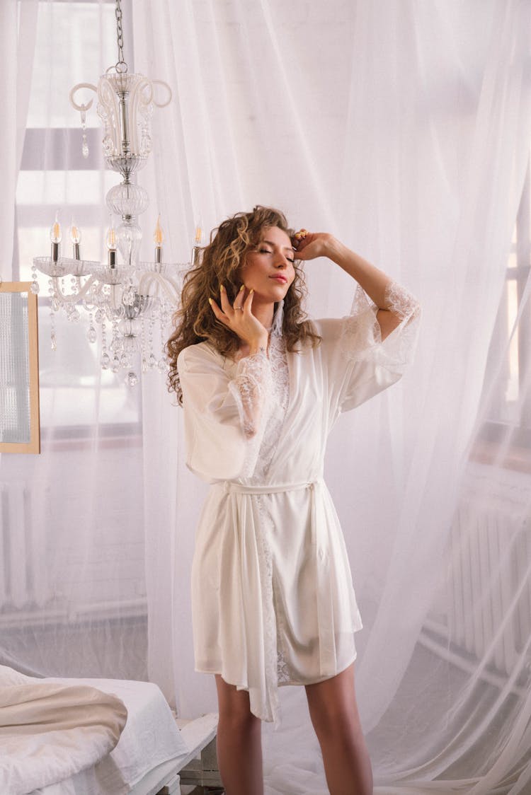 Woman In White Laced Robe Standing Near White Curtain