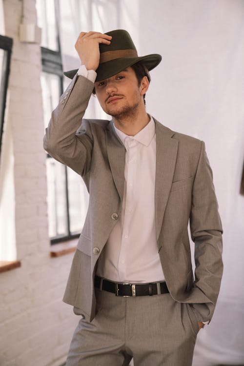 A Young Man in Gray Suit and a Black Hat