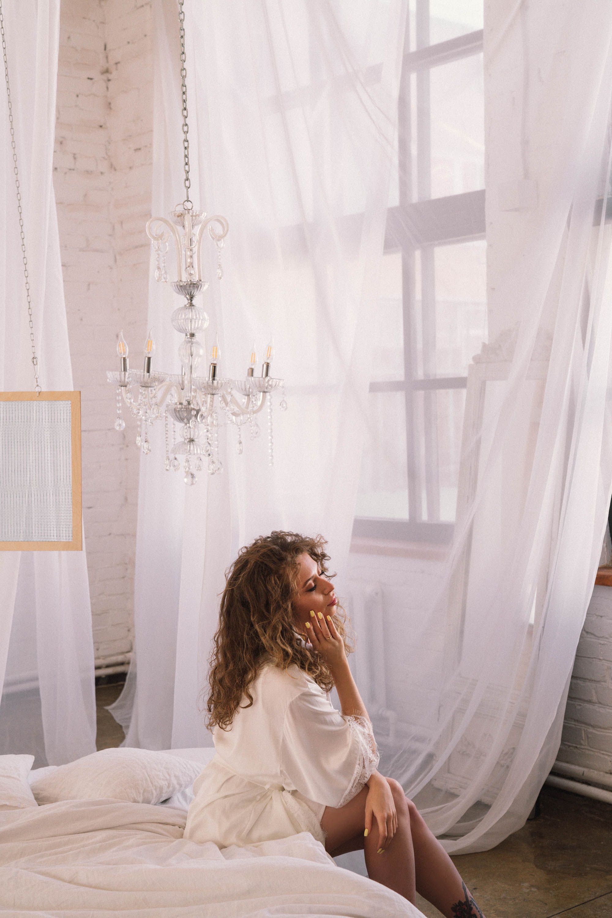 A Woman in White Dress Sitting on Bed · Free Stock Photo
