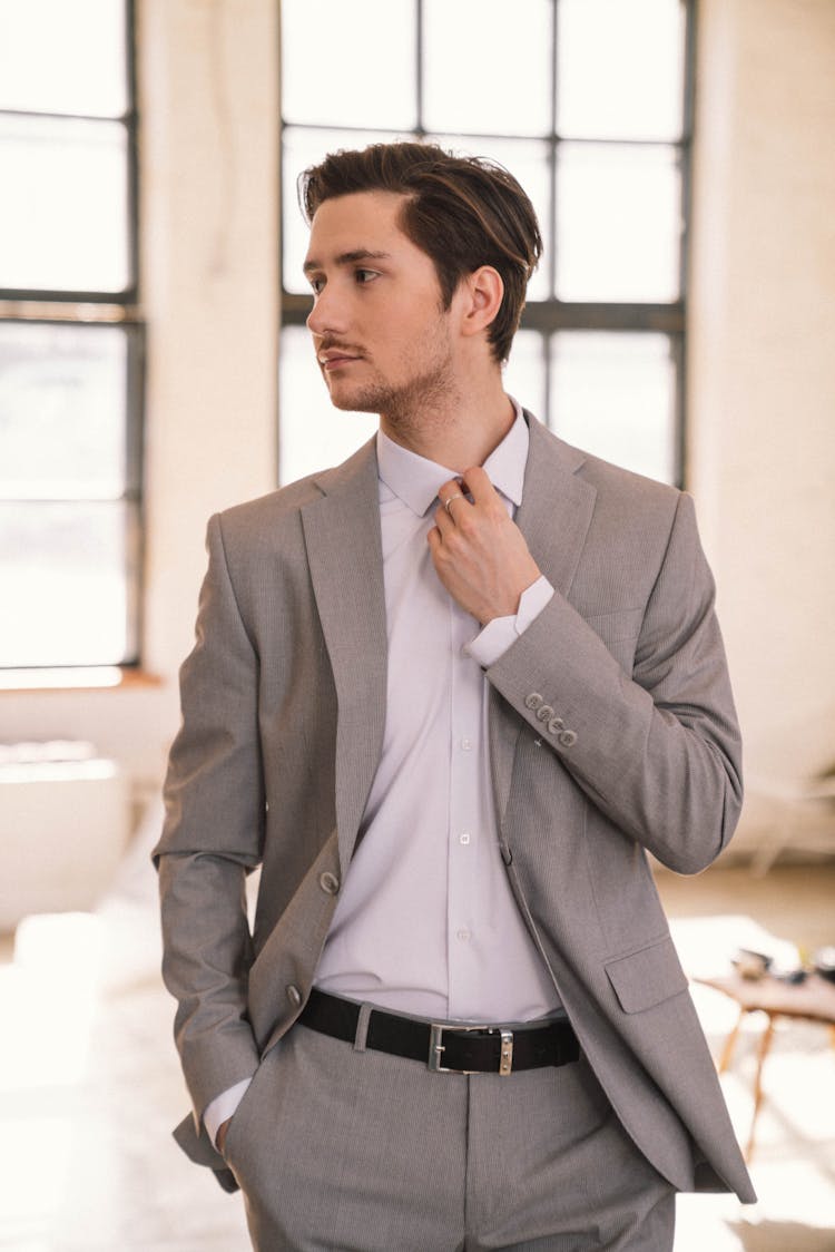 A Man In Gray Suit Looking Sideways