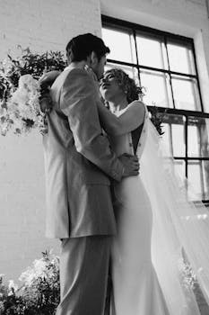 Bride and groom share an intimate embrace in a graceful wedding moment.