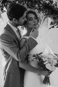 Sophisticated monochrome portrait of a bride and groom embracing.