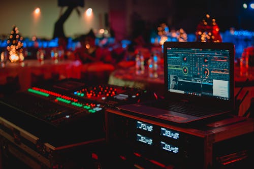 Free Black Laptop Beside Audio Mixer Set Stock Photo