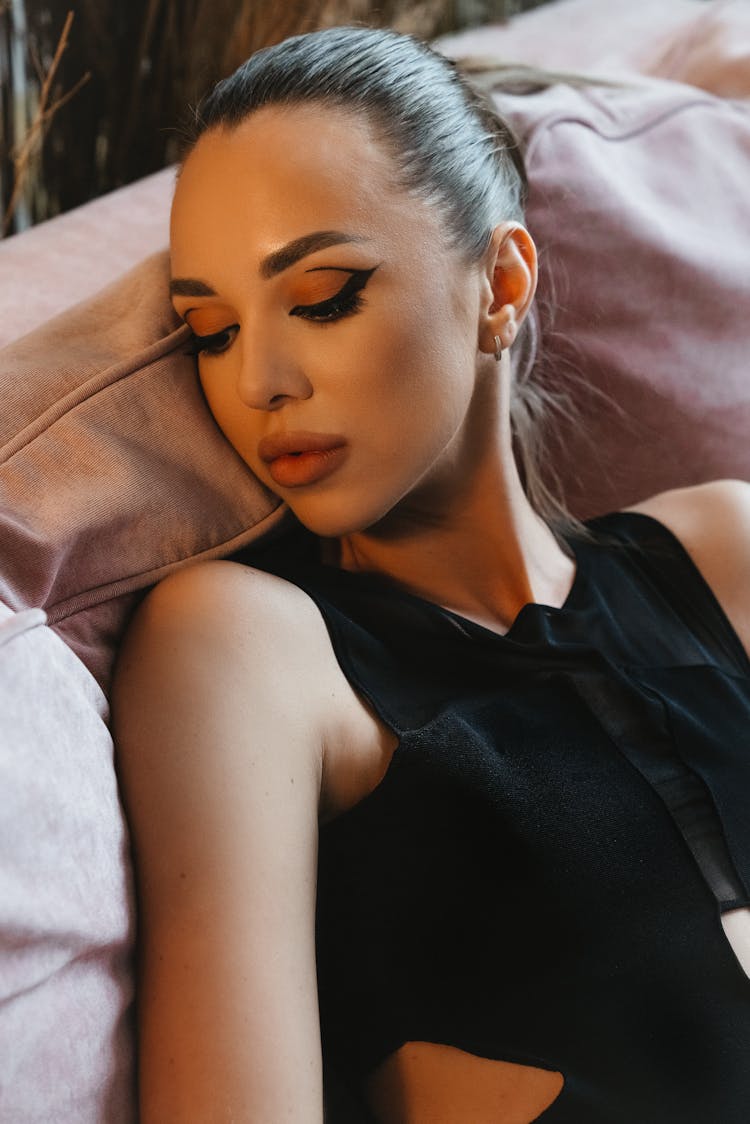 Woman In Black Sleeveless Top Lying Down