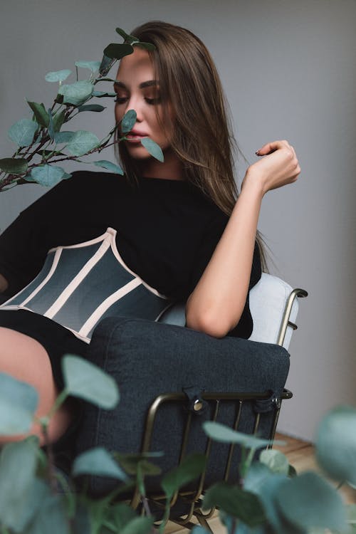 Model Sitting in Chair Posing with Plants