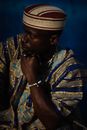 Man in Blue and Brown Tribal Print Shirt Wearing Gray and Black Hat