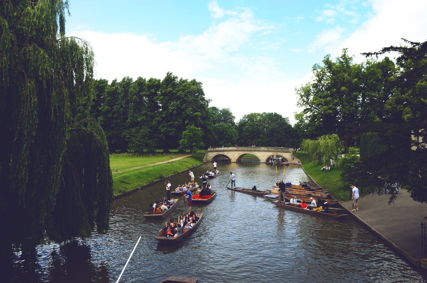 People enjoying recreational boating on a picturesque canal
