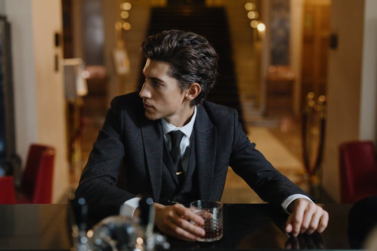 Man Sitting At The Bar Counter Looking Sideways