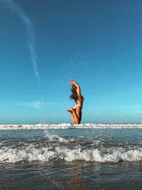 Woman in Bikini Jumping High Stock Image - Image of activity