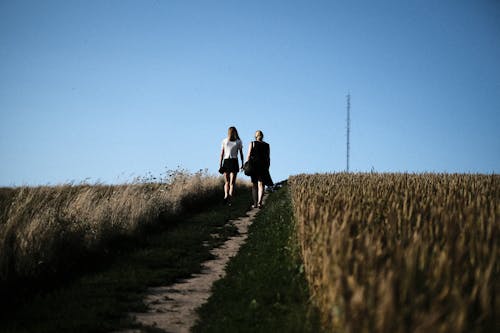 Women walking between Grasslands