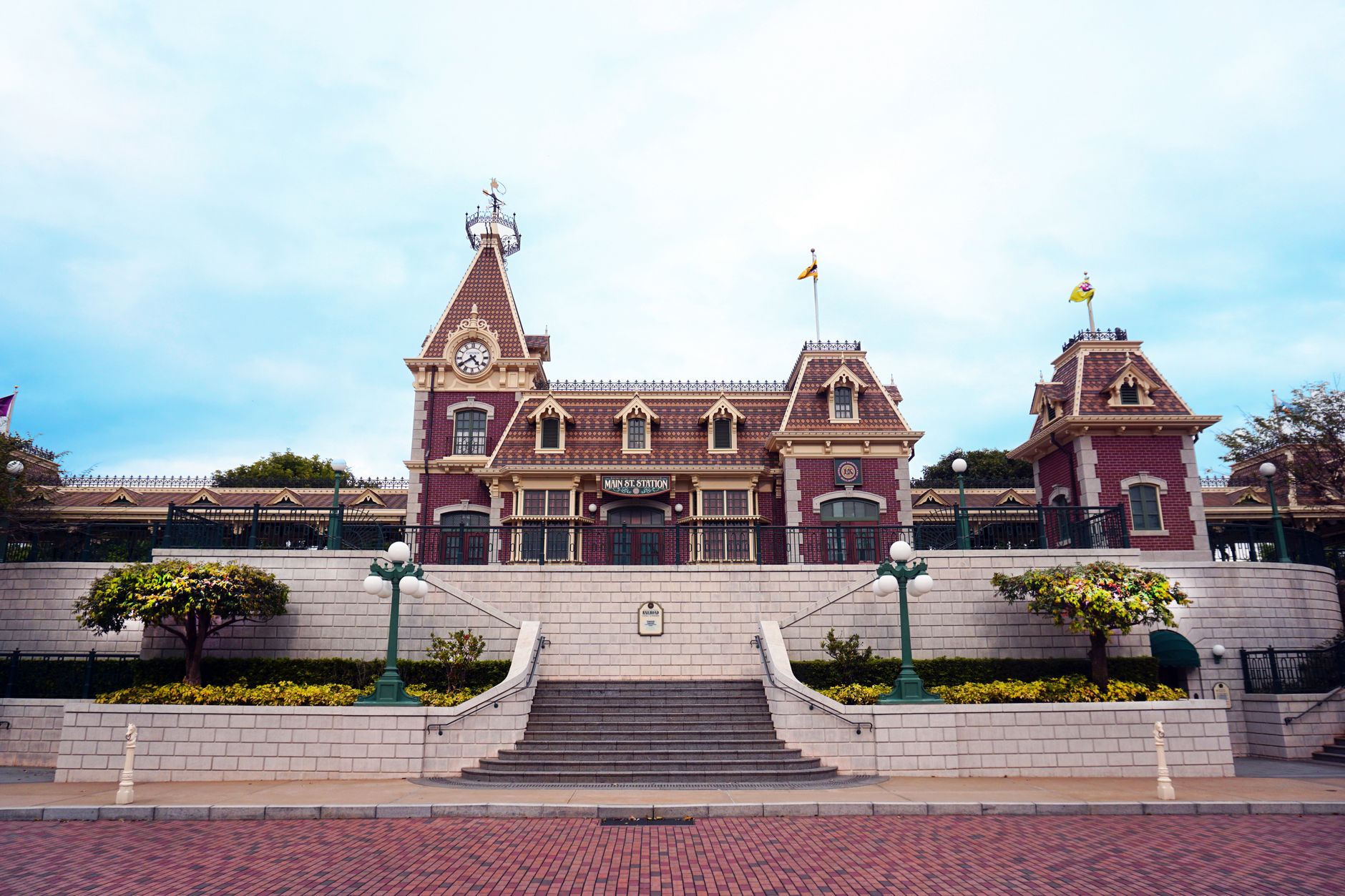 Iconic Main Street Station at Hong Kong Disneyland, showcasing Victorian architecture.
