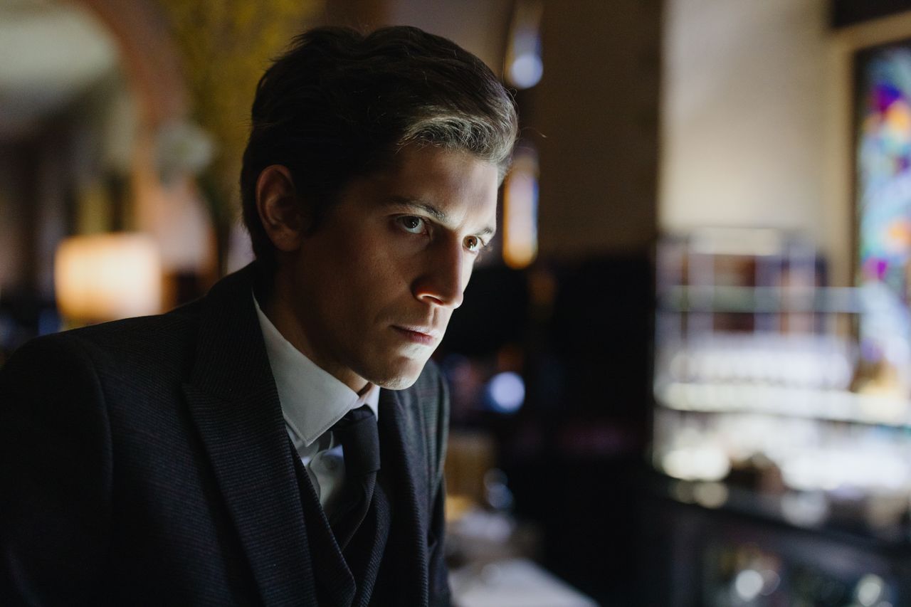 close up of a thoughtful man in a black suit in an elegant indoor sett
