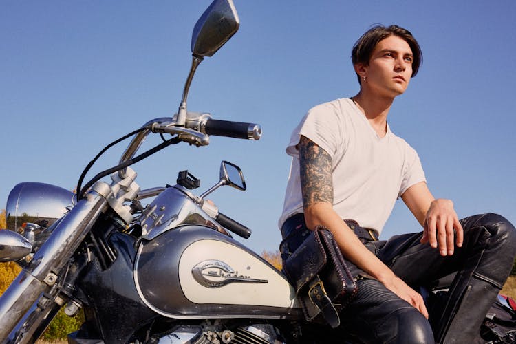 A Handsome Man Sitting On A Motorcycle