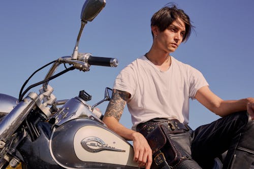 Free Person in White Shirt Sitting on Motorcycle Stock Photo
