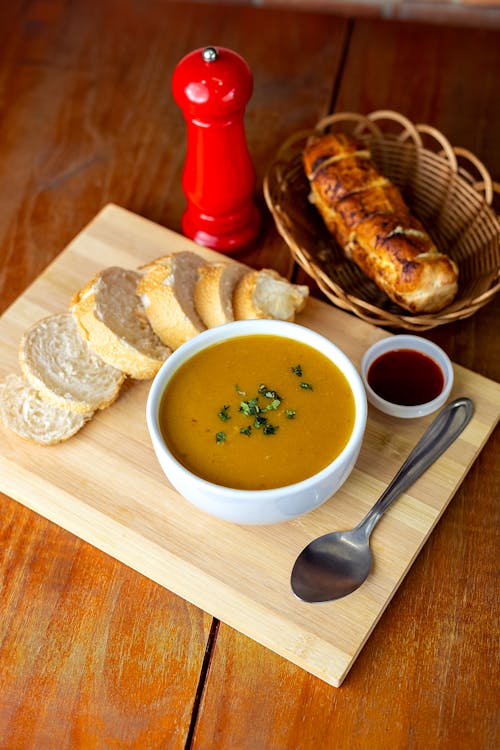 Free Bowl of Soup on a Wooden Chopping Board Stock Photo