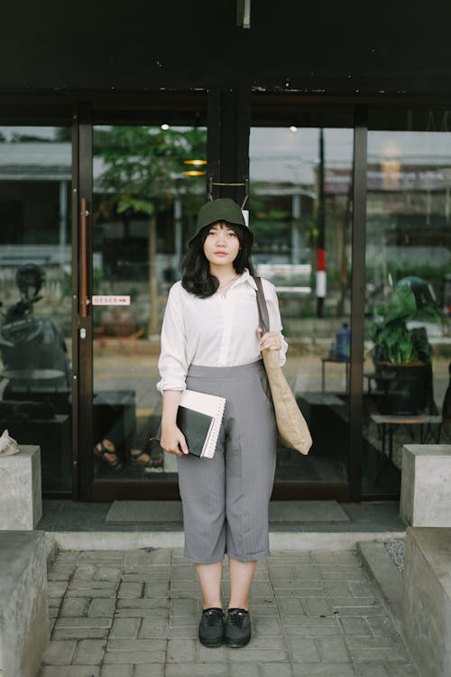 Woman in White Long Sleeve Shirt and Gray Pants