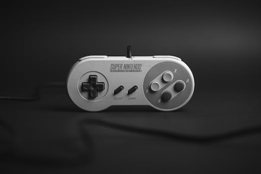 Vintage Super Nintendo controller in monochrome on a dark background, highlighting gaming nostalgia.