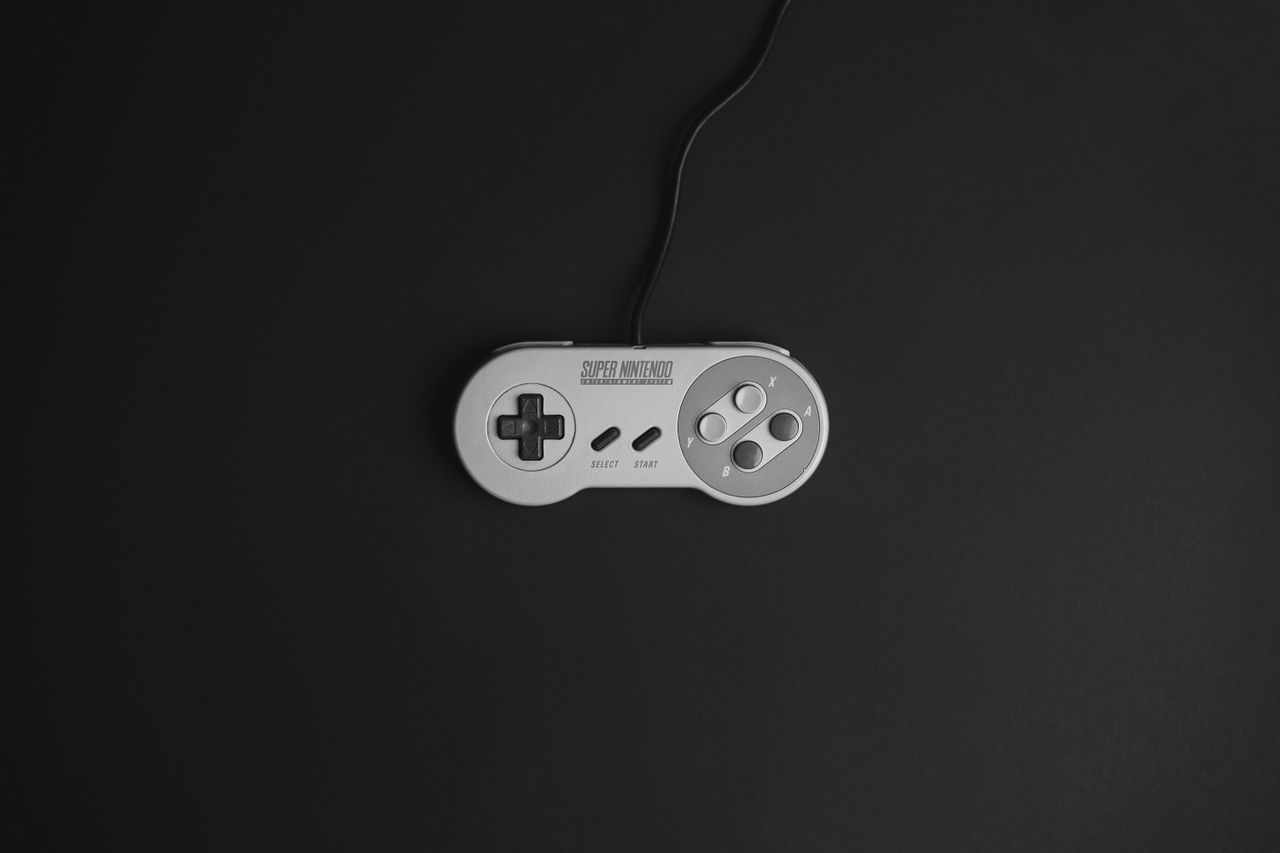 super nintendo game controller on a black background vintage gaming th