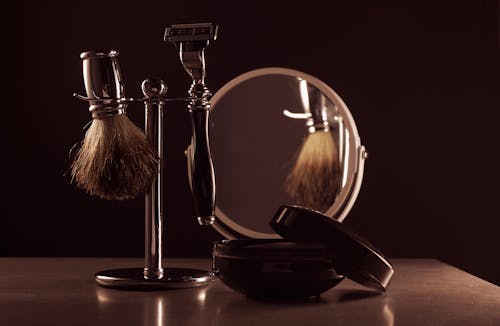 Beard Grooming Tools and Mirror on Table