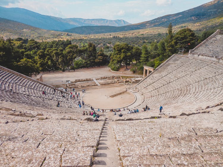 Tourists At The Ancient Theatre Of Epidaurus In Greece