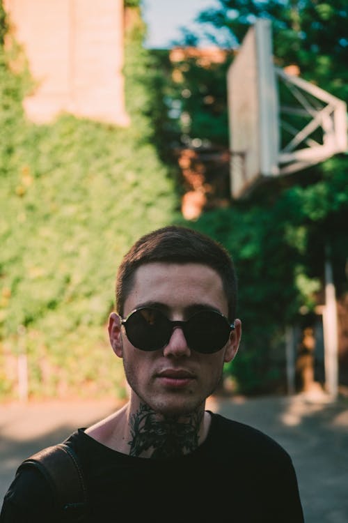  Man with Tattoo on Neck Wearing Black Sunglasses