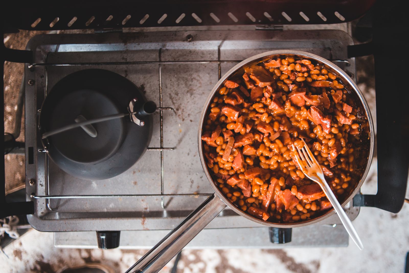 Pan of cooked beans in a kitchen