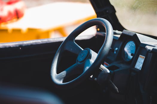 Detailed interior view of a vehicle dashboard and steering wheel, focused on controls.