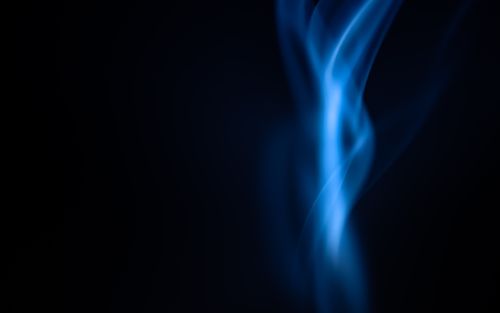 Free Elegant blue flame against a dark backdrop, creating a mysterious, abstract visual. Stock Photo