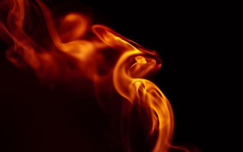 Free Bright orange flames in dynamic motion create a stunning abstract pattern against a black backdrop. Stock Photo