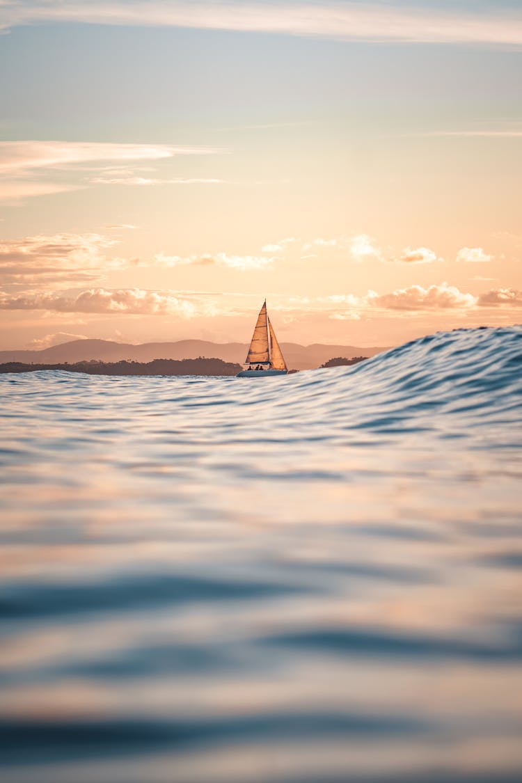 Sailboat Sailing At Sea During Sunset