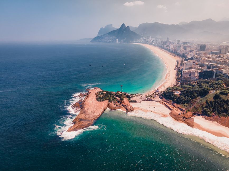 Ultimate Rio de Janeiro Helicopter Tour - Christ the Redeemer Review Review 2026 - Stunning aerial view of Rio de Janeiro's coastline showcasing vibrant beaches and mountains in the distance.