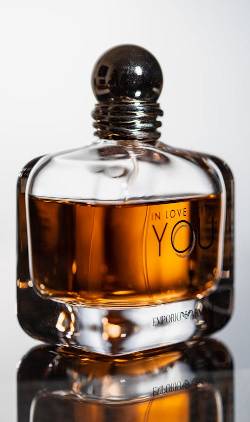 Bottle of Perfume on Glass Surface