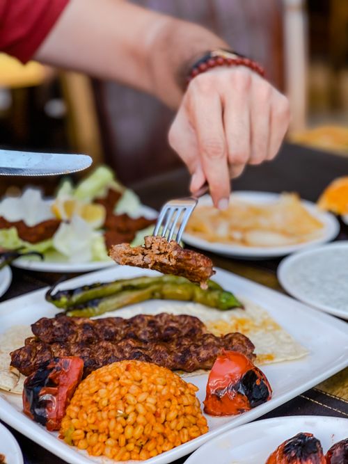 Free A tempting kebab dish with grilled vegetables and bulgur, ready to savor on a dining table. Stock Photo