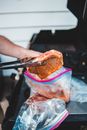 A Person Putting a Marinated Pork Inside the Zip Lock