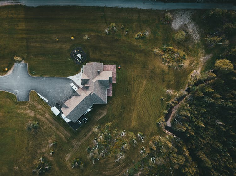 
An Aerial Shot Of A House With A Backyard