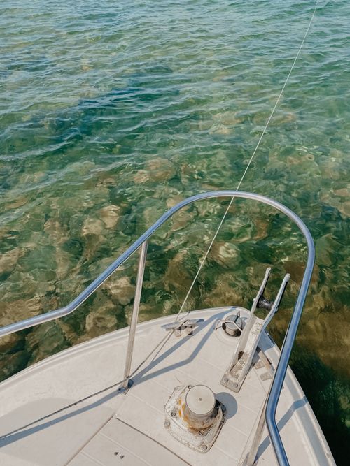 Free Experience serene sailing with a yacht navigating crystal clear waters, capturing tranquility and adventure. Stock Photo